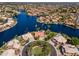 Stunning aerial view of waterfront homes surrounding a lake with lush landscaping and mature palm trees at 1241 W Lobster Trap Dr, Gilbert, AZ 85233