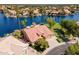 Stunning waterfront home with lush landscaping, private dock, and tile roof at 1241 W Lobster Trap Dr, Gilbert, AZ 85233