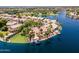 Waterfront home featuring well-manicured landscaping, a built-in fire pit, boat dock, and backyard patio at 1241 W Lobster Trap Dr, Gilbert, AZ 85233