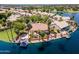 Waterfront home features a pool, boat dock, multiple patios, a built-in fireplace, and lush landscaping at 1241 W Lobster Trap Dr, Gilbert, AZ 85233