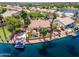 Waterfront home boasts a boat dock, stone patio, manicured landscaping, and gorgeous lake views at 1241 W Lobster Trap Dr, Gilbert, AZ 85233