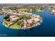 Aerial view of waterfront homes with lush landscaping and private docks on a point in a lake community at 1241 W Lobster Trap Dr, Gilbert, AZ 85233
