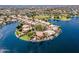 Aerial view of waterfront homes on a point with lush landscaping and private docks on a sunny day at 1241 W Lobster Trap Dr, Gilbert, AZ 85233