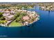 Luxurious waterfront estate featuring a private dock, boat, and palm trees at 1241 W Lobster Trap Dr, Gilbert, AZ 85233