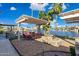 Backyard with outdoor kitchen, pergola covered patio, fire features and lake views at 1241 W Lobster Trap Dr, Gilbert, AZ 85233