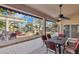 Covered patio overlooking a serene backyard with a fire feature and waterfront view at 1241 W Lobster Trap Dr, Gilbert, AZ 85233