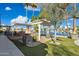 Inviting backyard with lake views, fire features, pergola, outdoor kitchen, and lush landscaping at 1241 W Lobster Trap Dr, Gilbert, AZ 85233