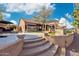 The gorgeous backyard boasts a patio, outdoor kitchen, a pergola, and stunning waterfront views at 1241 W Lobster Trap Dr, Gilbert, AZ 85233