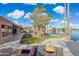 Expansive backyard featuring a patio, outdoor kitchen, pergola, and scenic waterfront views at 1241 W Lobster Trap Dr, Gilbert, AZ 85233
