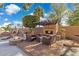 Private backyard with stone fireplace, outdoor seating, and lush landscaping perfect for outdoor entertainment at 1241 W Lobster Trap Dr, Gilbert, AZ 85233