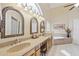 Bright bathroom featuring dual sinks, soaking tub, and vanity seating at 1241 W Lobster Trap Dr, Gilbert, AZ 85233