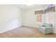 Bright and airy bedroom with neutral carpet and light blue armchair at 1241 W Lobster Trap Dr, Gilbert, AZ 85233