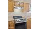 Close up view of stainless steel stove and wood cabinets at 1241 W Lobster Trap Dr, Gilbert, AZ 85233