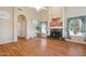 Open living room with wood floors, a fireplace and lots of natural light at 1241 W Lobster Trap Dr, Gilbert, AZ 85233