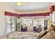 Bright bedroom with waterside views, seating, and an ensuite bathroom at 1241 W Lobster Trap Dr, Gilbert, AZ 85233