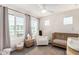 Cozy Bedroom featuring natural light, a comfortable glider, and warm accents for a peaceful environment at 1250 N Abbey Ln # 206, Chandler, AZ 85226