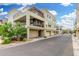 Contemporary three-story condo building with multiple balconies and attached garages at 1250 N Abbey Ln # 206, Chandler, AZ 85226