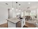 Bright, modern kitchen featuring an island with bar seating, white cabinets, and open layout at 1250 N Abbey Ln # 206, Chandler, AZ 85226