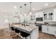 Open kitchen with white cabinets, marble countertops, and a view into the dining area at 1250 N Abbey Ln # 206, Chandler, AZ 85226