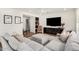 Bright living room featuring a plush sectional sofa, a large television, and modern decor at 1250 N Abbey Ln # 206, Chandler, AZ 85226