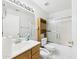 Well-lit bathroom featuring a vanity with sink, toilet, and tiled shower-tub at 13431 N 30Th St, Phoenix, AZ 85032