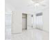 Bedroom featuring tile floors, fan, and mirrored closet with open door access at 13431 N 30Th St, Phoenix, AZ 85032