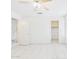 Bright bedroom with tile flooring, ceiling fan, and access to a closet at 13431 N 30Th St, Phoenix, AZ 85032