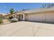Wide driveway leads to a two-car garage of this charming, single-story home with desert landscaping at 13431 N 30Th St, Phoenix, AZ 85032