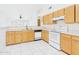 Bright kitchen features white appliances, oak cabinets, and tile flooring at 13431 N 30Th St, Phoenix, AZ 85032