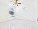 Bright room with a tile floor, arched window, and ceiling fan with light at 13431 N 30Th St, Phoenix, AZ 85032