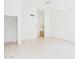 Spacious living room with neutral walls, tile flooring, and a doorway with vanity view at 13431 N 30Th St, Phoenix, AZ 85032