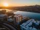 Sunset aerial view of a river, buildings, and mountains in the distance at 140 E Rio Salado Pkwy # 1006, Tempe, AZ 85281