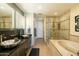 Modern bathroom with double sinks, granite countertop, bathtub and glass enclosed shower at 140 E Rio Salado Pkwy # 1006, Tempe, AZ 85281