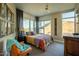Bedroom featuring a bed, nightstand and an orange chair with large windows at 140 E Rio Salado Pkwy # 1006, Tempe, AZ 85281