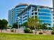Exterior daytime shot of modern condominium building with balconies and lush landscaping at 140 E Rio Salado Pkwy # 1006, Tempe, AZ 85281