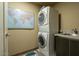 Laundry room featuring a stacked washer and dryer, a utility sink and a map on the wall at 140 E Rio Salado Pkwy # 1006, Tempe, AZ 85281