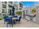 Outdoor kitchen and dining area with built-in grills and vibrant blue seating at 140 E Rio Salado Pkwy # 1006, Tempe, AZ 85281