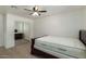 Comfortable bedroom with a ceiling fan, neutral decor, and an mirrored closet at 1408 E Orange St, Tempe, AZ 85281