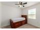 Well-lit bedroom features a ceiling fan, window and a stylish wooden bed frame at 1408 E Orange St, Tempe, AZ 85281