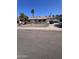 Well-kept single-story home with a decorative rock yard, featuring a black iron fence at 1408 E Orange St, Tempe, AZ 85281