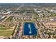 Expansive aerial view of a lake community surrounded by residences and green spaces, offering an overview of the neighborhood layout at 1442 W Laurel Ave, Gilbert, AZ 85233