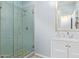 Modern bathroom featuring a vanity with sink and storage, glass shower and decorative lighting at 1442 W Laurel Ave, Gilbert, AZ 85233