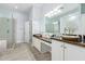 Bathroom featuring double vanities, granite countertops, a glass-enclosed shower, and tile flooring for a luxurious feel at 1442 W Laurel Ave, Gilbert, AZ 85233
