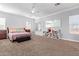 Comfortable bedroom with large window, neutral carpet, and ceiling fan at 1442 W Laurel Ave, Gilbert, AZ 85233