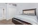 Comfortable bedroom showcasing a dark wood bed frame, plush carpeting, and soft, natural light at 1442 W Laurel Ave, Gilbert, AZ 85233