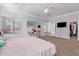 Bright bedroom featuring neutral walls, plush carpeting, a ceiling fan, and an opening to the Primary bath at 1442 W Laurel Ave, Gilbert, AZ 85233