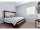 Comfortable bedroom showcasing a dark wood bed frame, plush carpeting, and soft, natural light at 1442 W Laurel Ave, Gilbert, AZ 85233