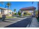 View of the beautiful gated entrance to Playa Del Rey, a recreational community with lush landscaping at 1442 W Laurel Ave, Gilbert, AZ 85233