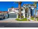 Stunning two-story home featuring an arched entryway, three-car garage, and lush landscaping, all under a clear blue sky at 1442 W Laurel Ave, Gilbert, AZ 85233
