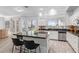 Bright kitchen featuring an island with bar seating, stainless steel appliances, tile flooring, and natural light from the windows at 1442 W Laurel Ave, Gilbert, AZ 85233
